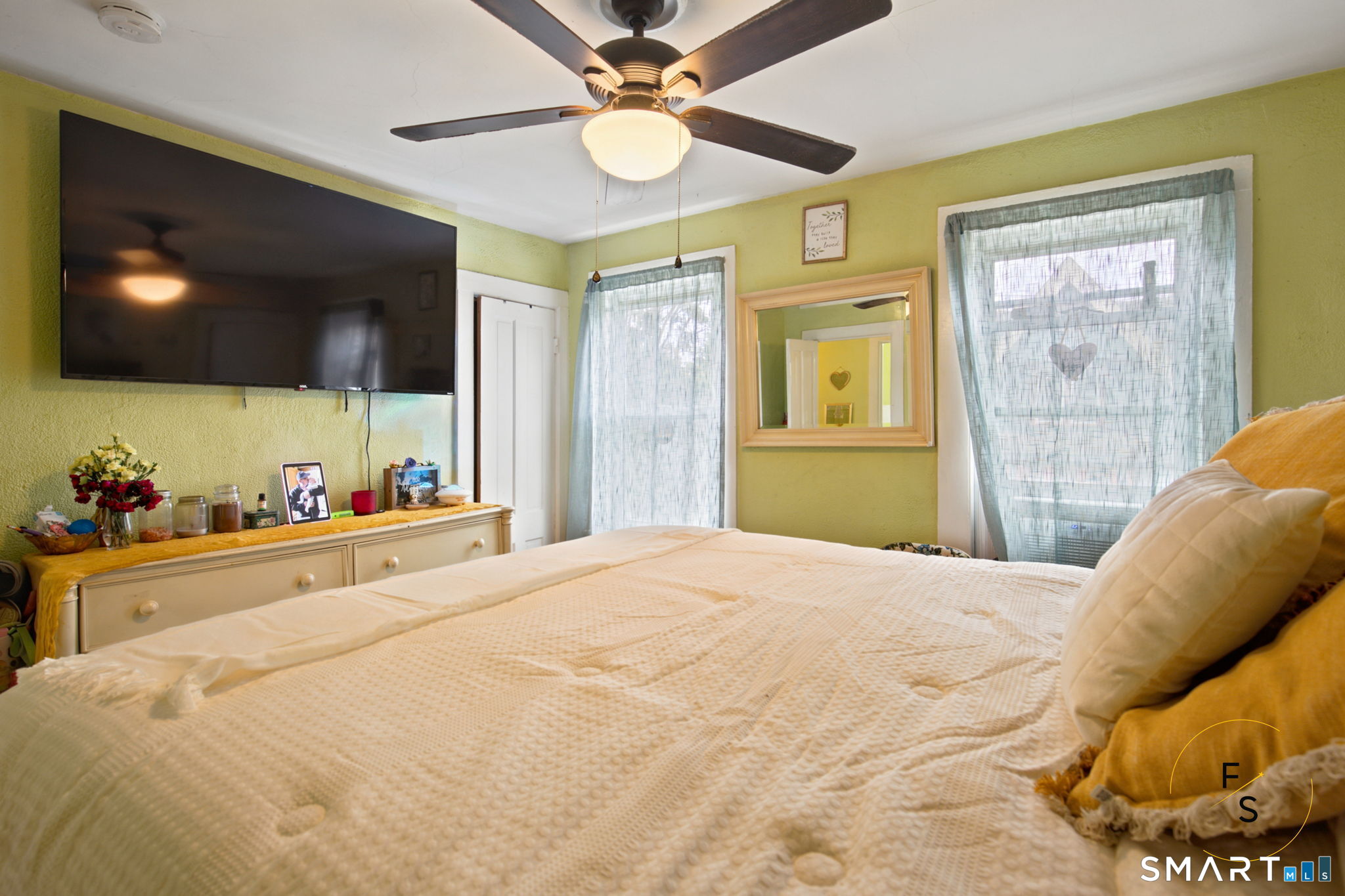 182 Broad Street Norwich, CT 06360 - Photo 24 of 30 a bedroom with a bed and a flat screen tv