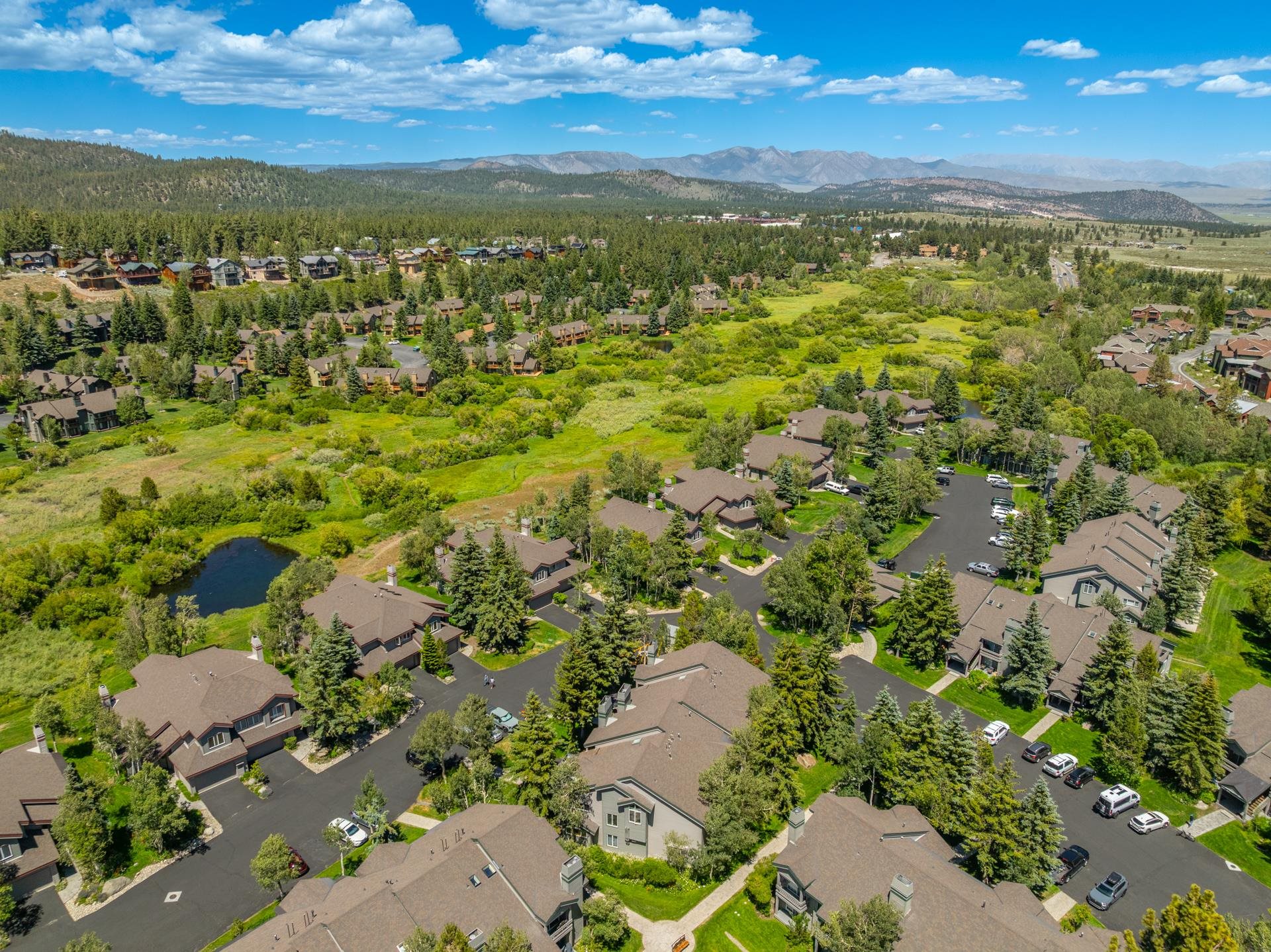 609 Golden Creek Road, Unit 609 Mammoth Lakes, CA 93546 - Photo 39 of 42 Aerial perspective showcasing a residential community nestled within a verdant landscape