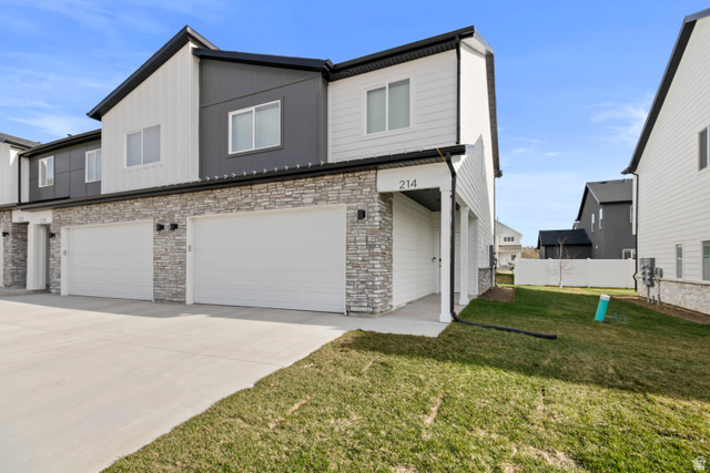 1262 West 500 South Logan, UT 84321 - Photo 2 of 39 Modern two-story townhome with a grey and white exterior, featuring a stacked stone facade