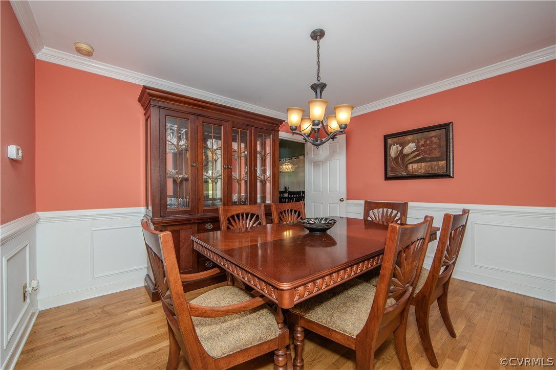 2306 Shadow Ridge Court Midlothian, VA 23112 - Photo 5 of 27 a view of a dining room with furniture chandelier and wooden floor