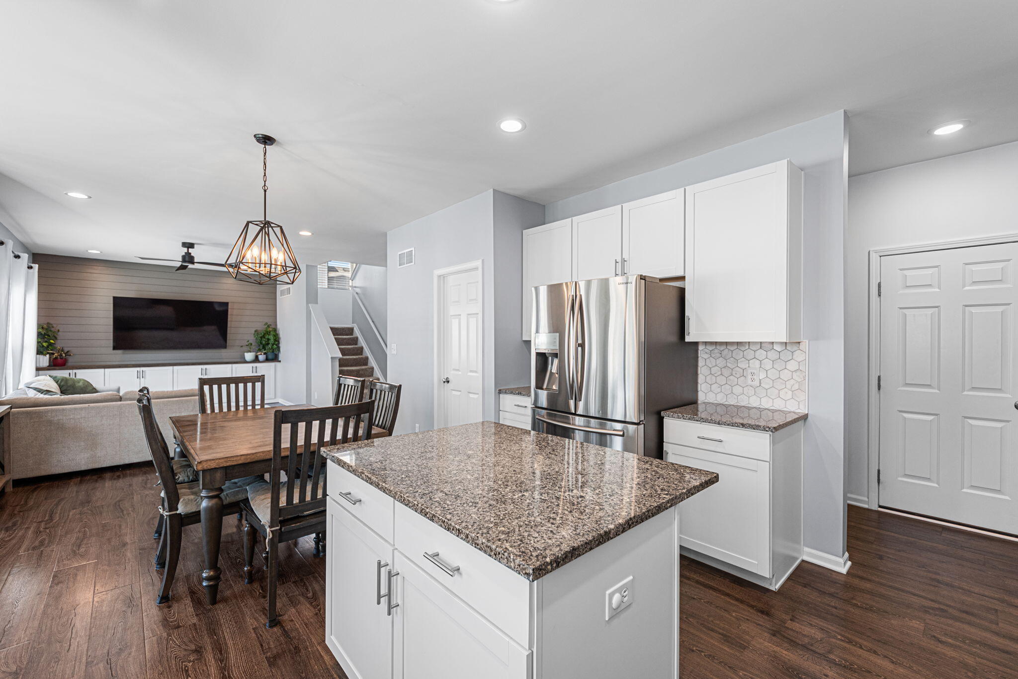2143 West 132nd Place Crown Point, IN 46307 - Photo 12 of 35 a kitchen with stainless steel appliances granite countertop a kitchen island a stove a table and chairs