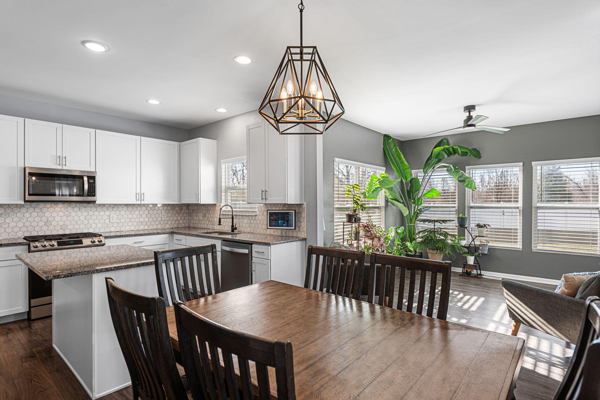 2143 West 132nd Place Crown Point, IN 46307 - Photo 14 of 35 a kitchen with stainless steel appliances granite countertop a stove a refrigerator a kitchen island a table and chairs