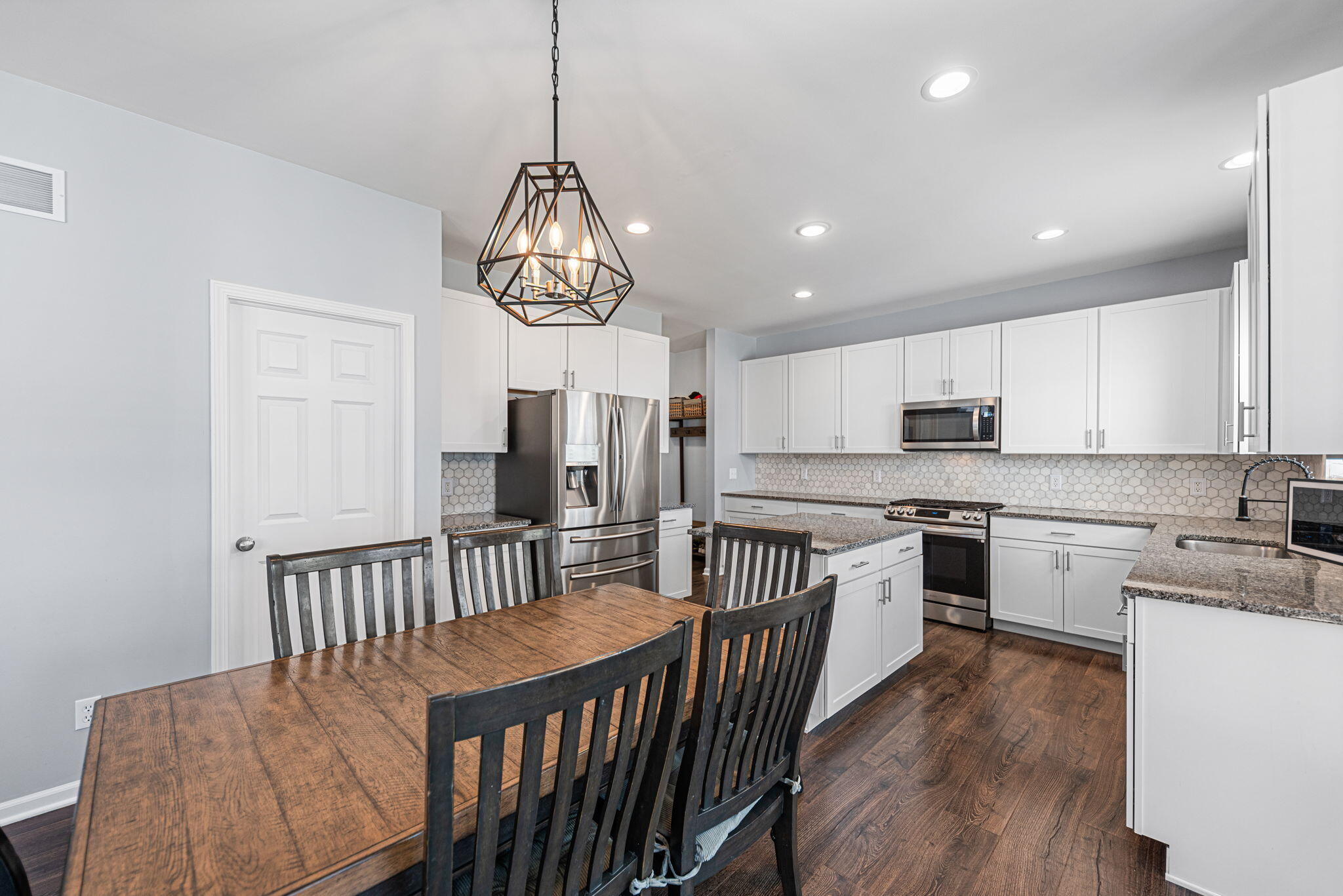 2143 West 132nd Place Crown Point, IN 46307 - Photo 17 of 35 a kitchen with stainless steel appliances granite countertop a kitchen island hardwood floor and a sink