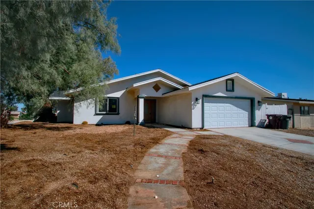 a front view of a house with yard and garage