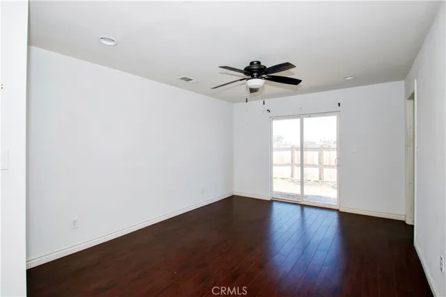 a view of a hallway with wooden floor and closet
