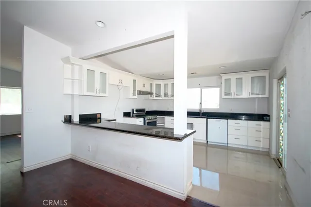 a kitchen with stainless steel appliances a sink and cabinets