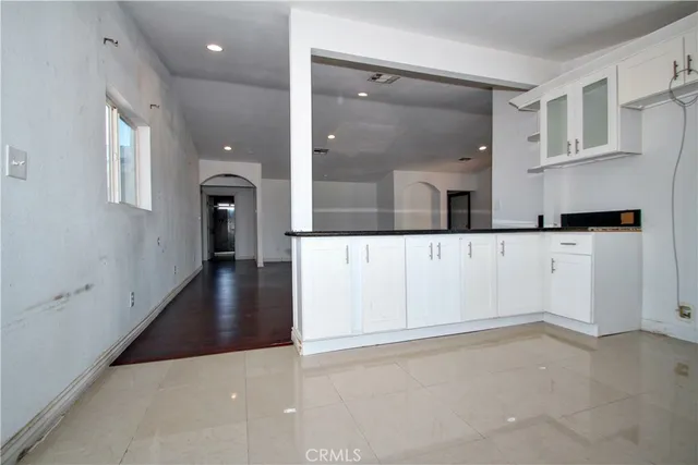 an empty room with windows and entrance