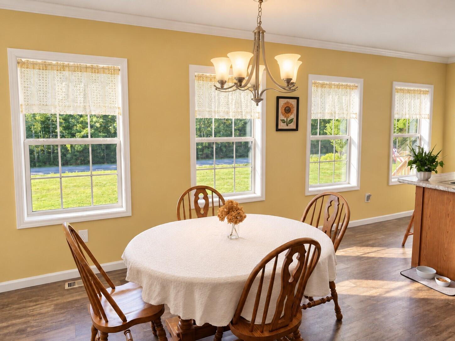 338 Marshfield Flats Road Marshfield, ME 04654 - Photo 8 of 26 Warm Dining Nook with Glowing Chandelier