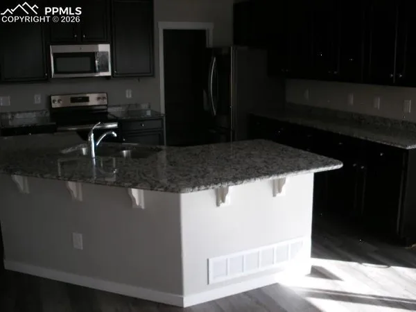 a kitchen with a sink and a microwave