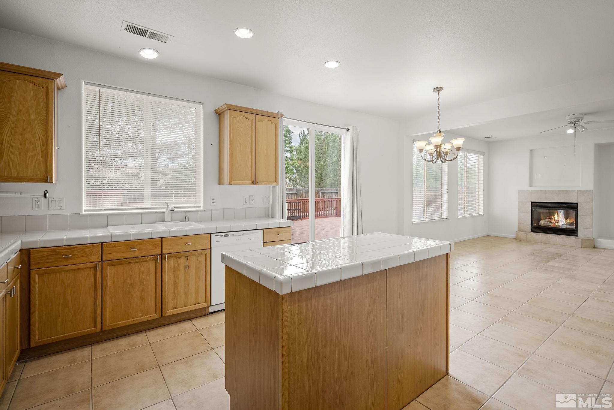 1722 Back Country Court Reno, NV 89521 - Photo 15 of 33 a kitchen with kitchen island granite countertop a sink cabinets and window