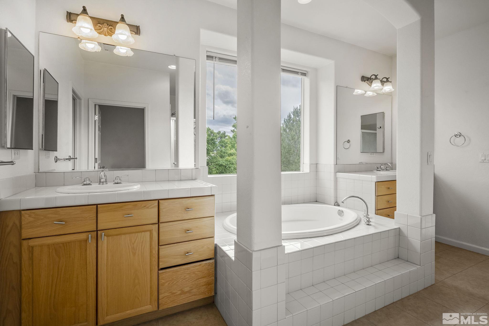 1722 Back Country Court Reno, NV 89521 - Photo 21 of 33 a bathroom with a tub sink and mirror