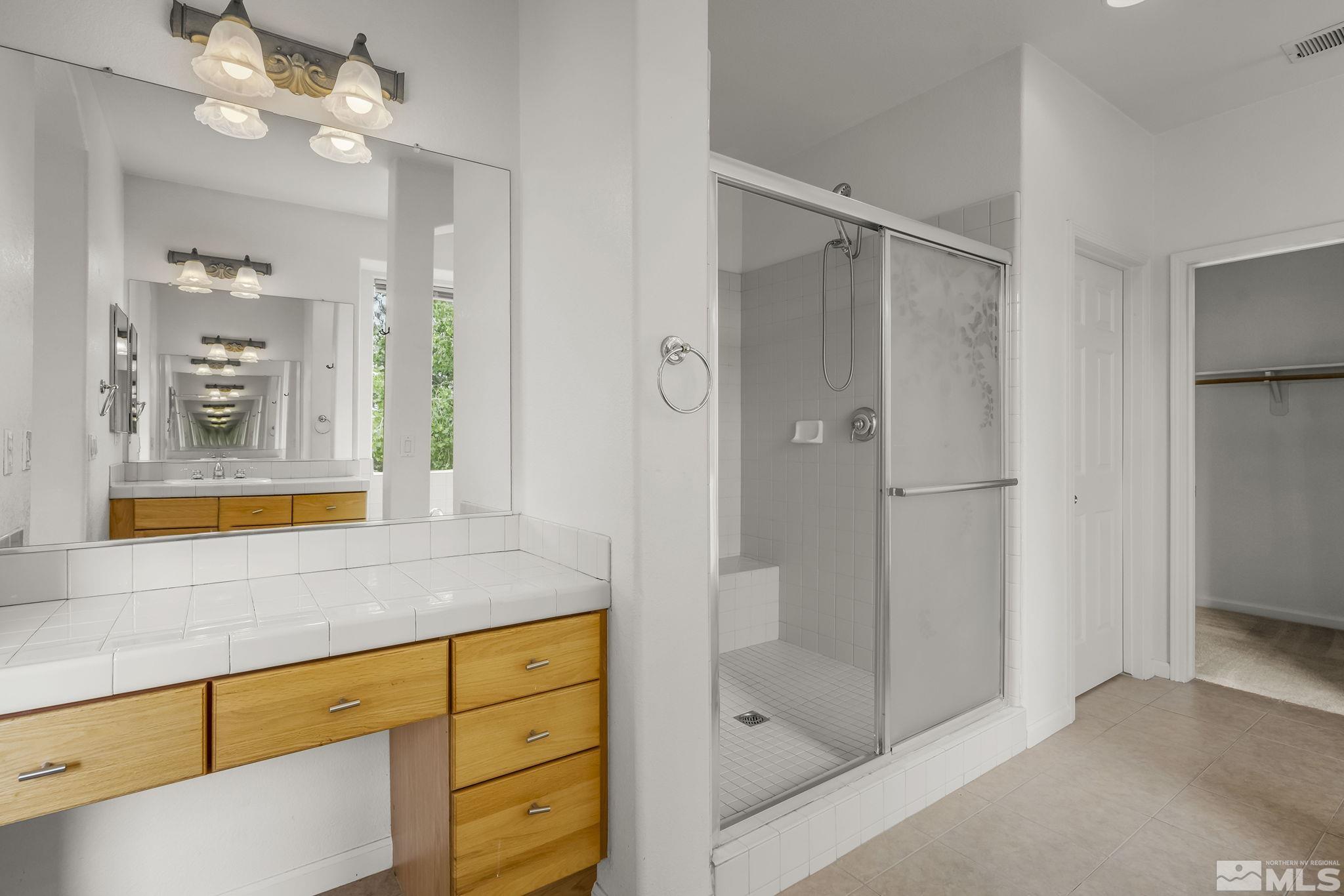 1722 Back Country Court Reno, NV 89521 - Photo 22 of 33 a bathroom with a shower sink and mirror