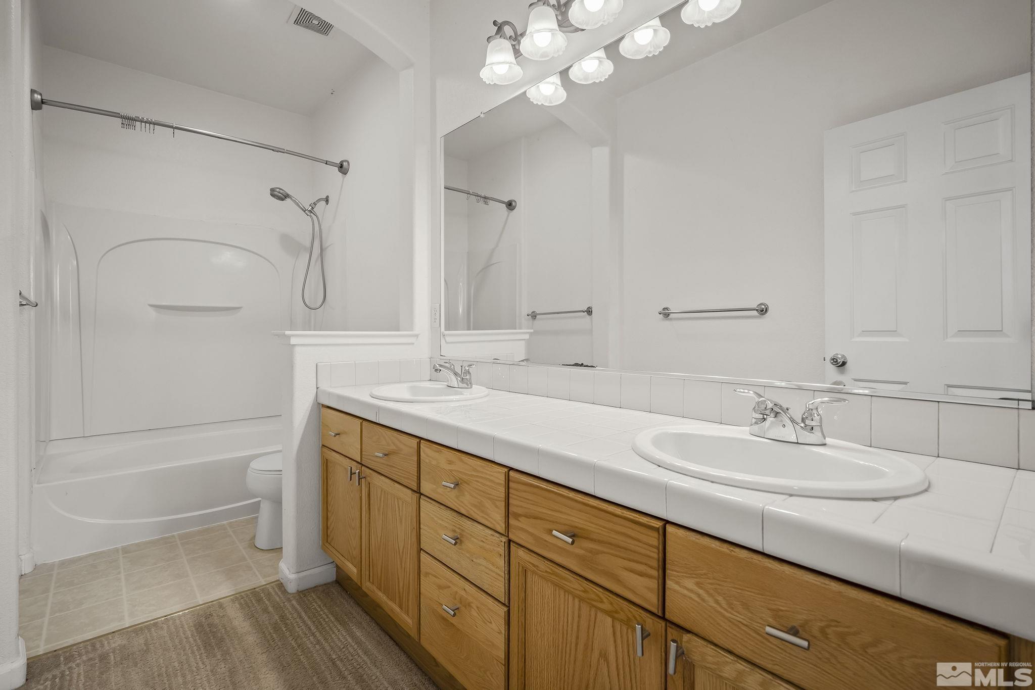1722 Back Country Court Reno, NV 89521 - Photo 26 of 33 a spacious bathroom with a double vanity sink a mirror and shower