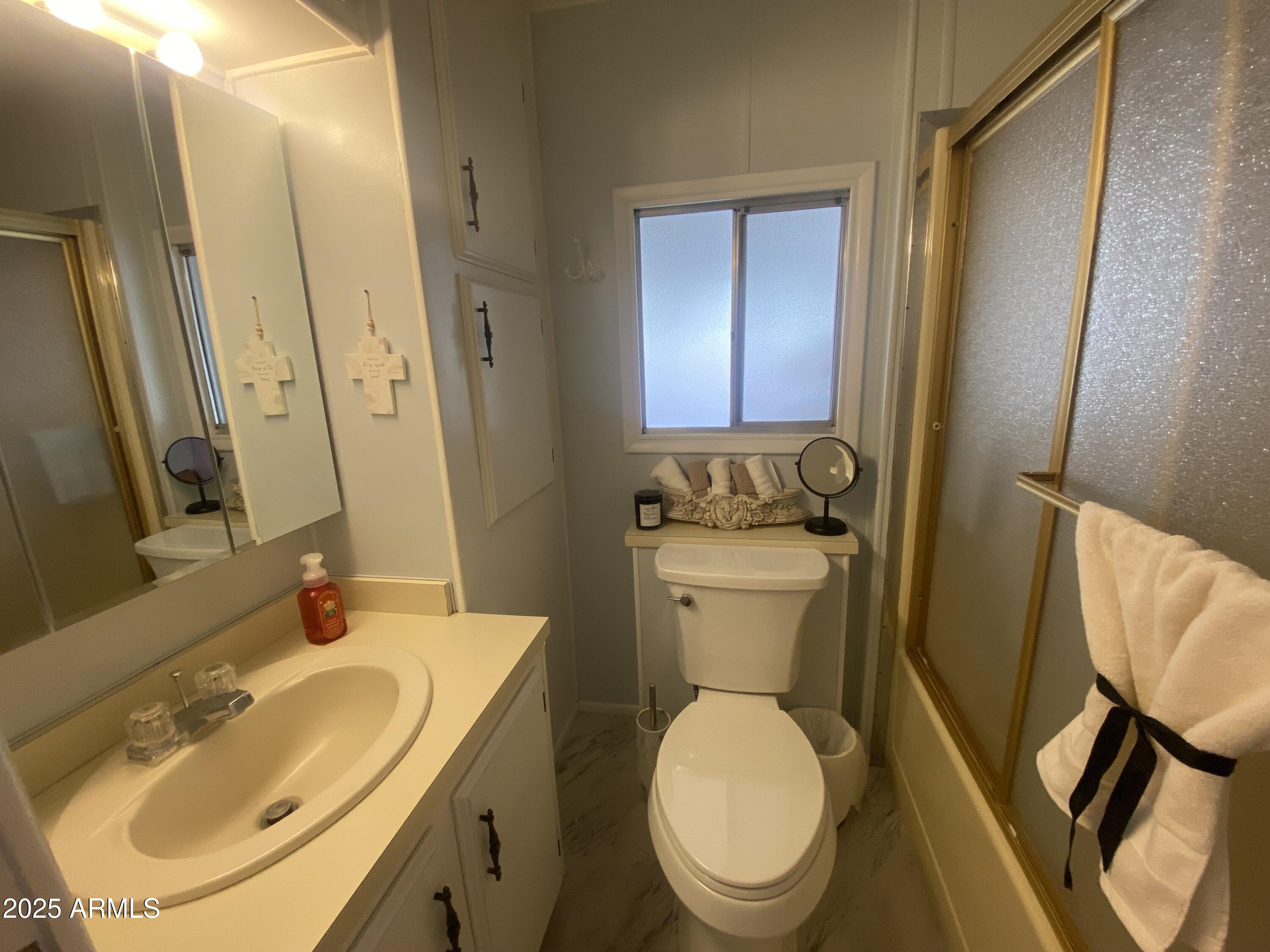 1135 South Sioux Drive Apache Junction, AZ 85119 - Photo 13 of 33 a bathroom with a toilet sink and mirror