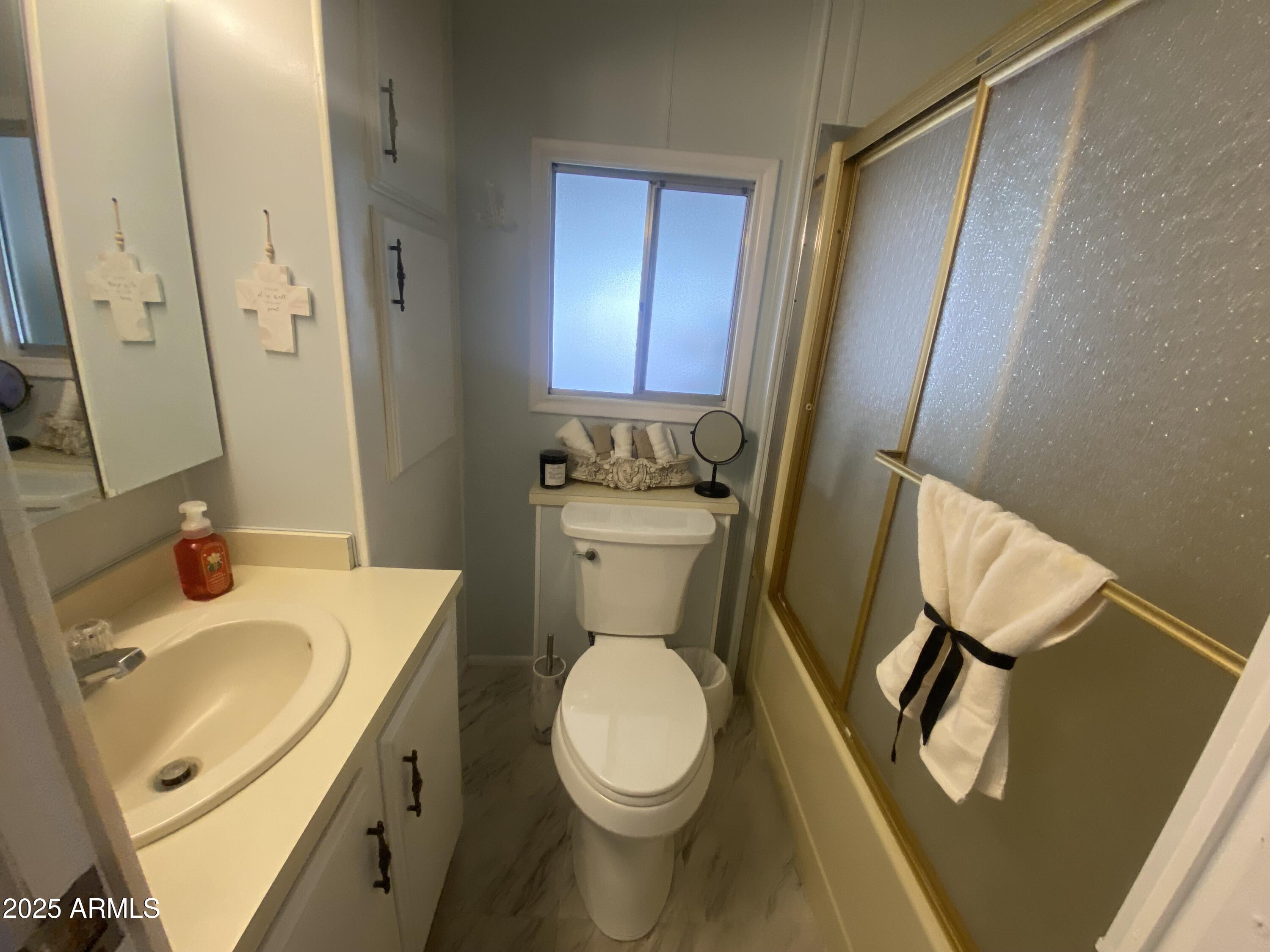 1135 South Sioux Drive Apache Junction, AZ 85119 - Photo 14 of 33 a bathroom with a sink a toilet and a mirror