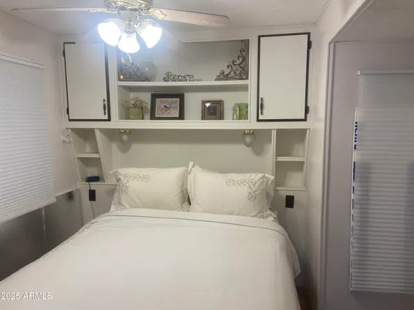 a bedroom with a bed and a chandelier