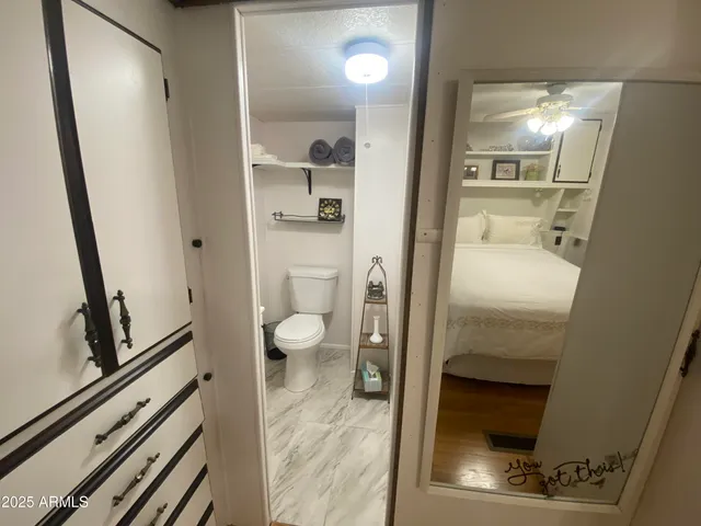 en bathroom with a toilet and a shower curtain