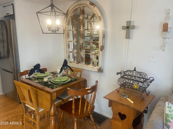 a dining room with furniture and wooden floor