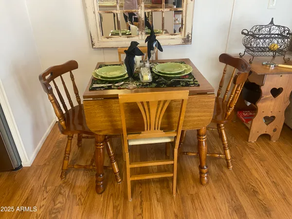 a view of a hallway with wooden floor and furniture