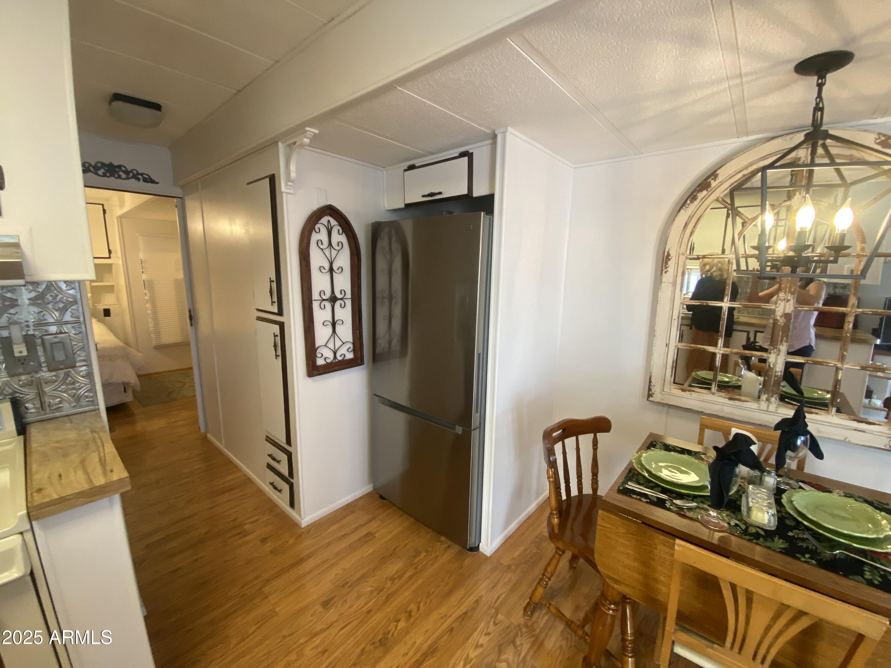 1135 South Sioux Drive Apache Junction, AZ 85119 - Photo 9 of 33 a view of a hallway with wooden floor and furniture
