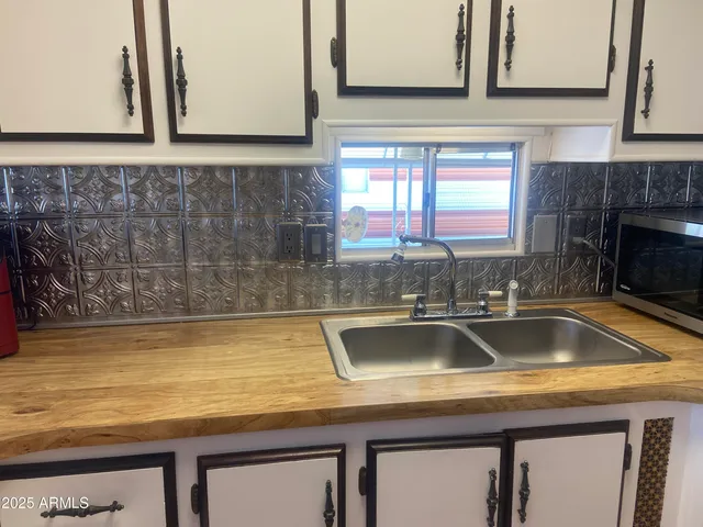 a bathroom with a granite countertop toilet sink and mirror