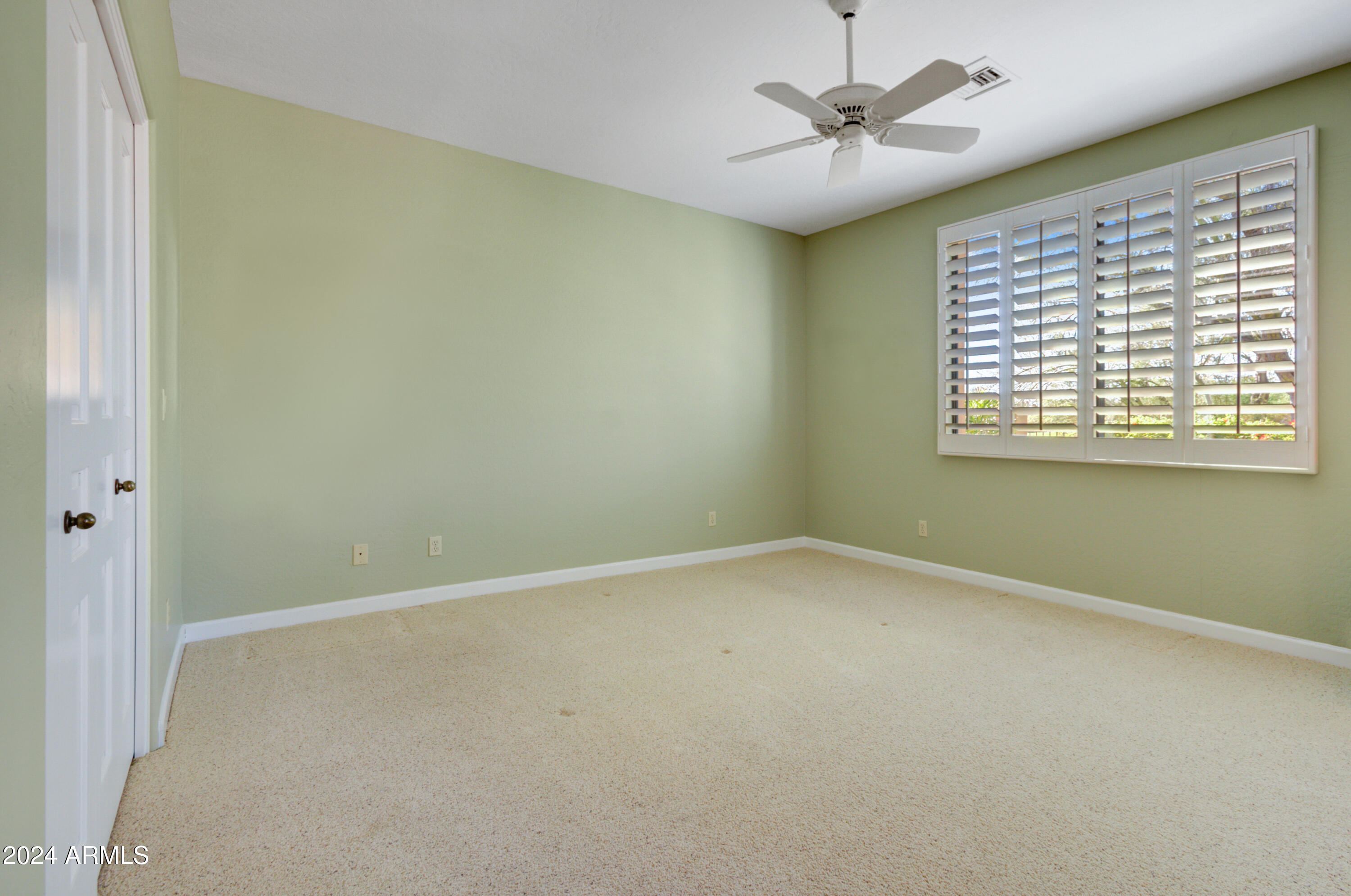 27820 North Lucero Drive Rio Verde, AZ 85263 - Photo 19 of 32 an empty room with a window and a fan