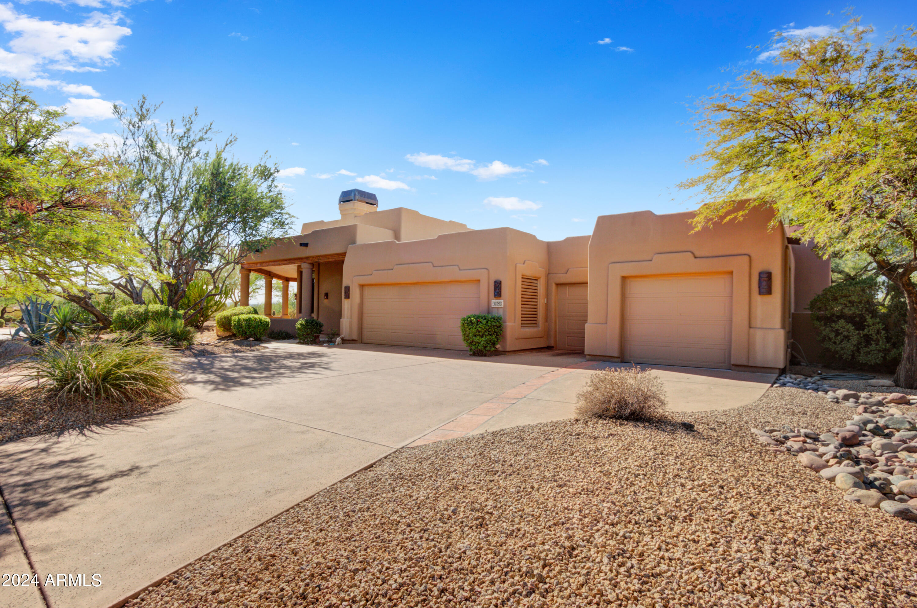 27820 North Lucero Drive Rio Verde, AZ 85263 - Photo 27 of 32 a front view of a house with a yard and garage