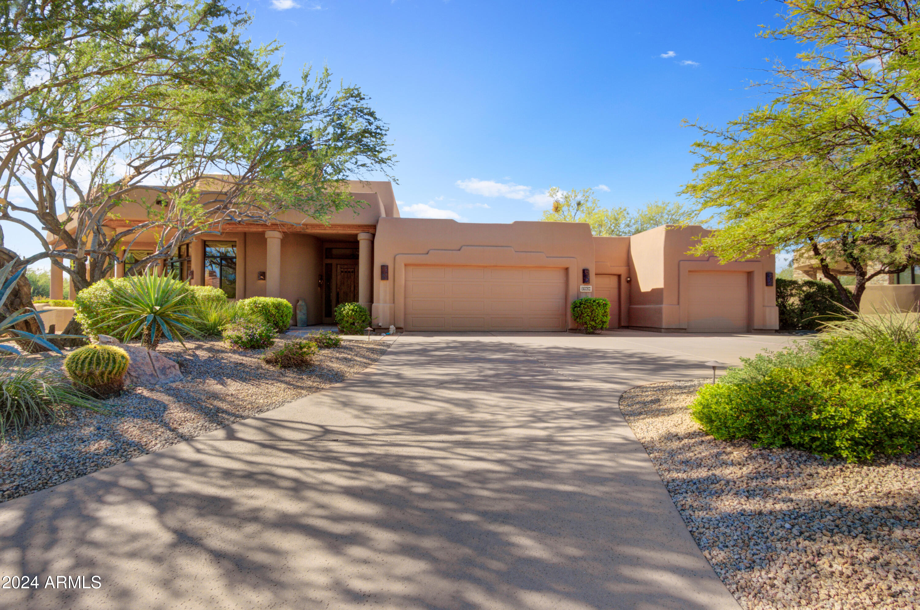 27820 North Lucero Drive Rio Verde, AZ 85263 - Photo 3 of 32 a front view of a house with a yard and potted plants