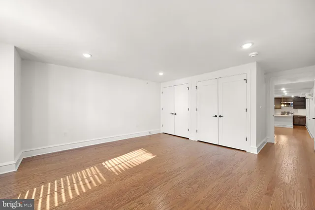 a view of an empty room with wooden floor