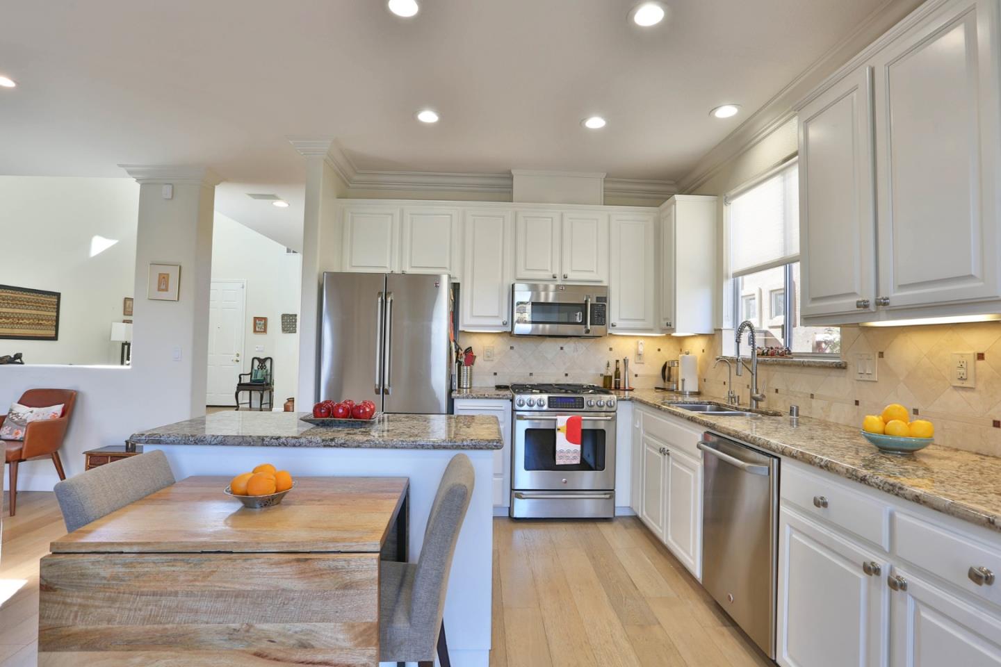 5409 Manderston Drive San Jose, CA 95138 - Photo 11 of 40 a kitchen with stainless steel appliances granite countertop a stove top oven a sink dishwasher and cabinets with wooden floor