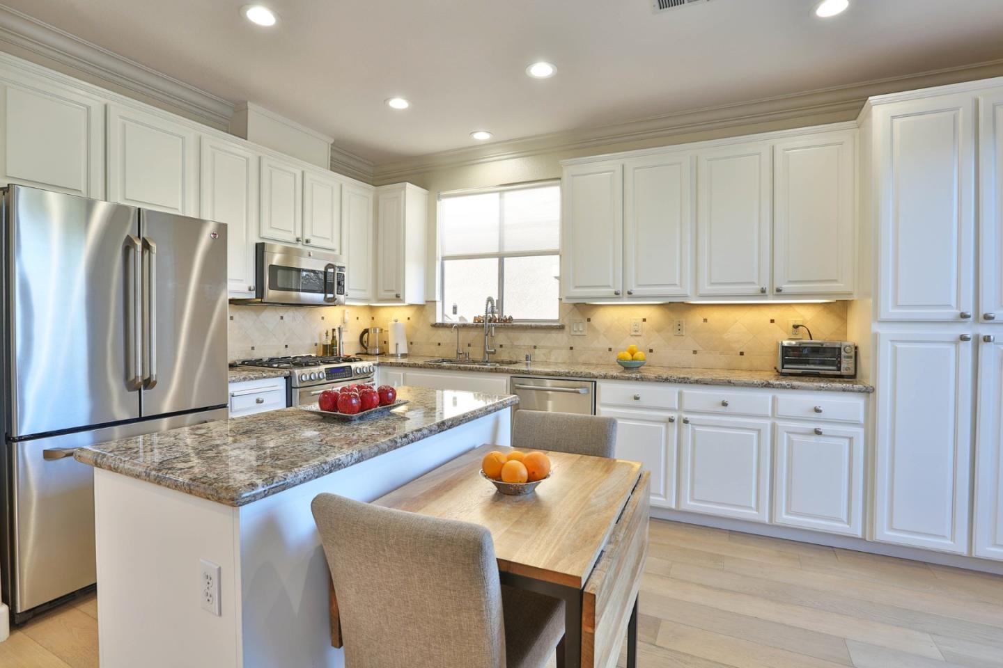 5409 Manderston Drive San Jose, CA 95138 - Photo 9 of 40 a kitchen with stainless steel appliances granite countertop a sink stove refrigerator and cabinets