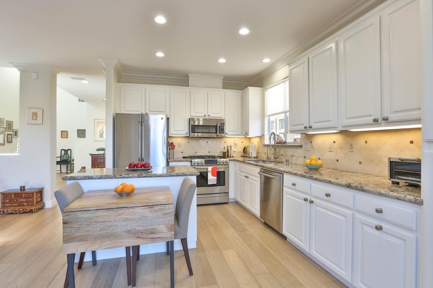 5409 Manderston Drive San Jose, CA 95138 - Photo 10 of 40 a kitchen with white cabinets and stainless steel appliances