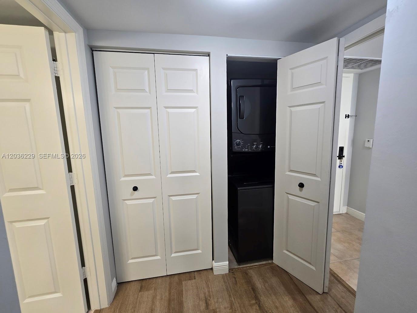 888 Douglas Road, Unit 605 Coral Gables, FL 33134 - Photo 19 of 21 an empty room with wooden floor and closet