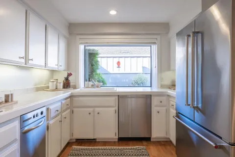a kitchen with a sink cabinets and window