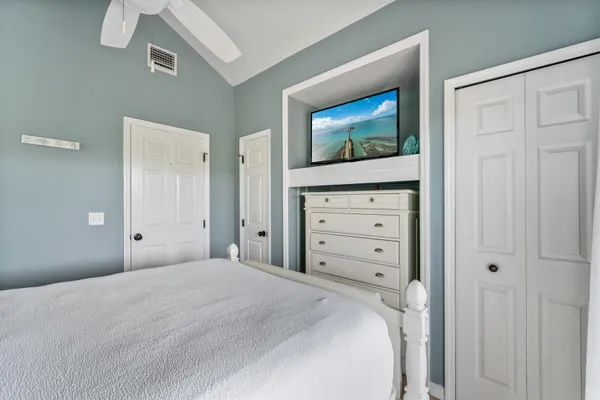 a bedroom with a bed and a television