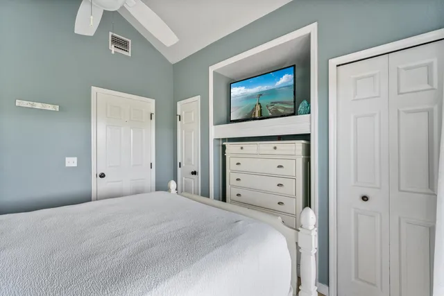 a bedroom with a bed and a television