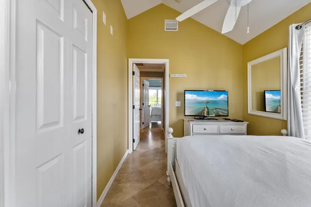 a bedroom with a bed and a television