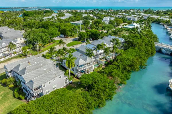 a view of a lake with lawn chairs