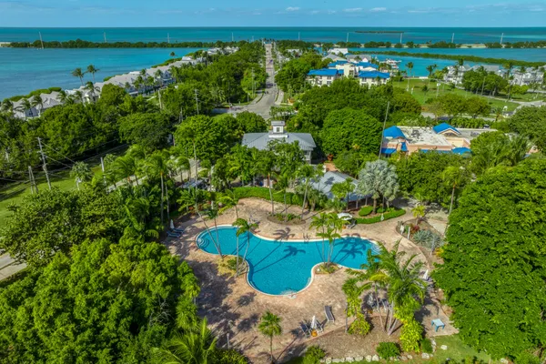 a view of a swimming pool with a yard and outdoor seating