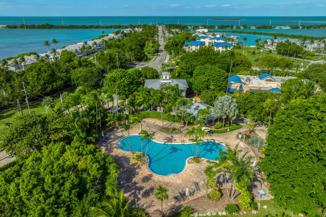 a view of a swimming pool with a yard and outdoor seating