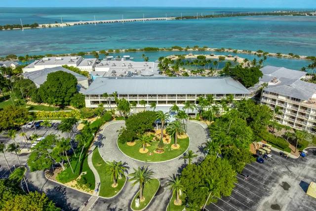 an aerial view of a house a yard basket ball court and outdoor seating