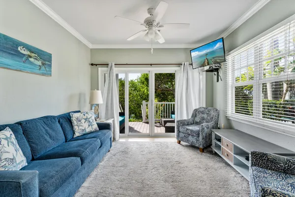 a living room with furniture and large windows
