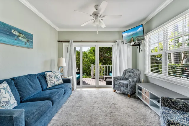 a living room with furniture and large windows
