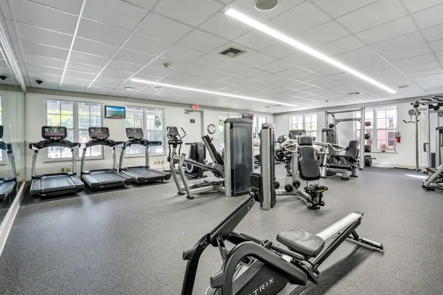a living room with furniture and large windows