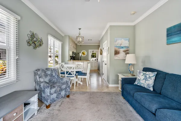 a living room with furniture and a chandelier