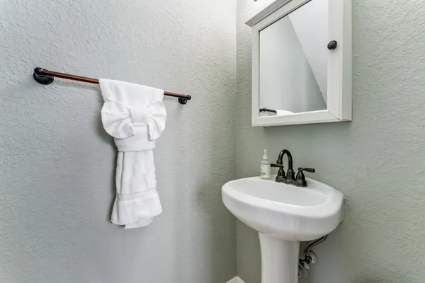 a bathroom with a sink a mirror and shower