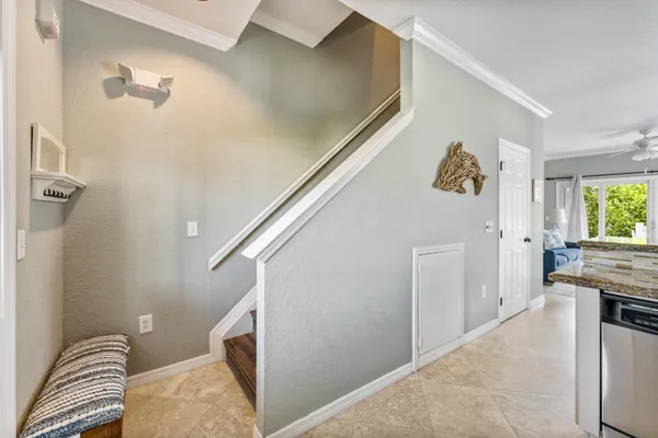 a view of a livingroom with furniture and staircase