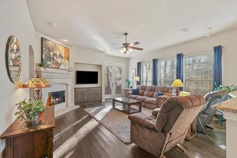 a living room with furniture a flat screen tv and a fireplace