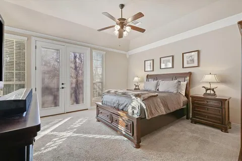 a spacious bedroom with a bed and a chandelier