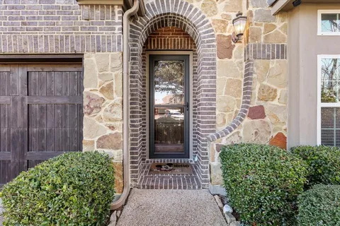 front view of a brick house with a large door